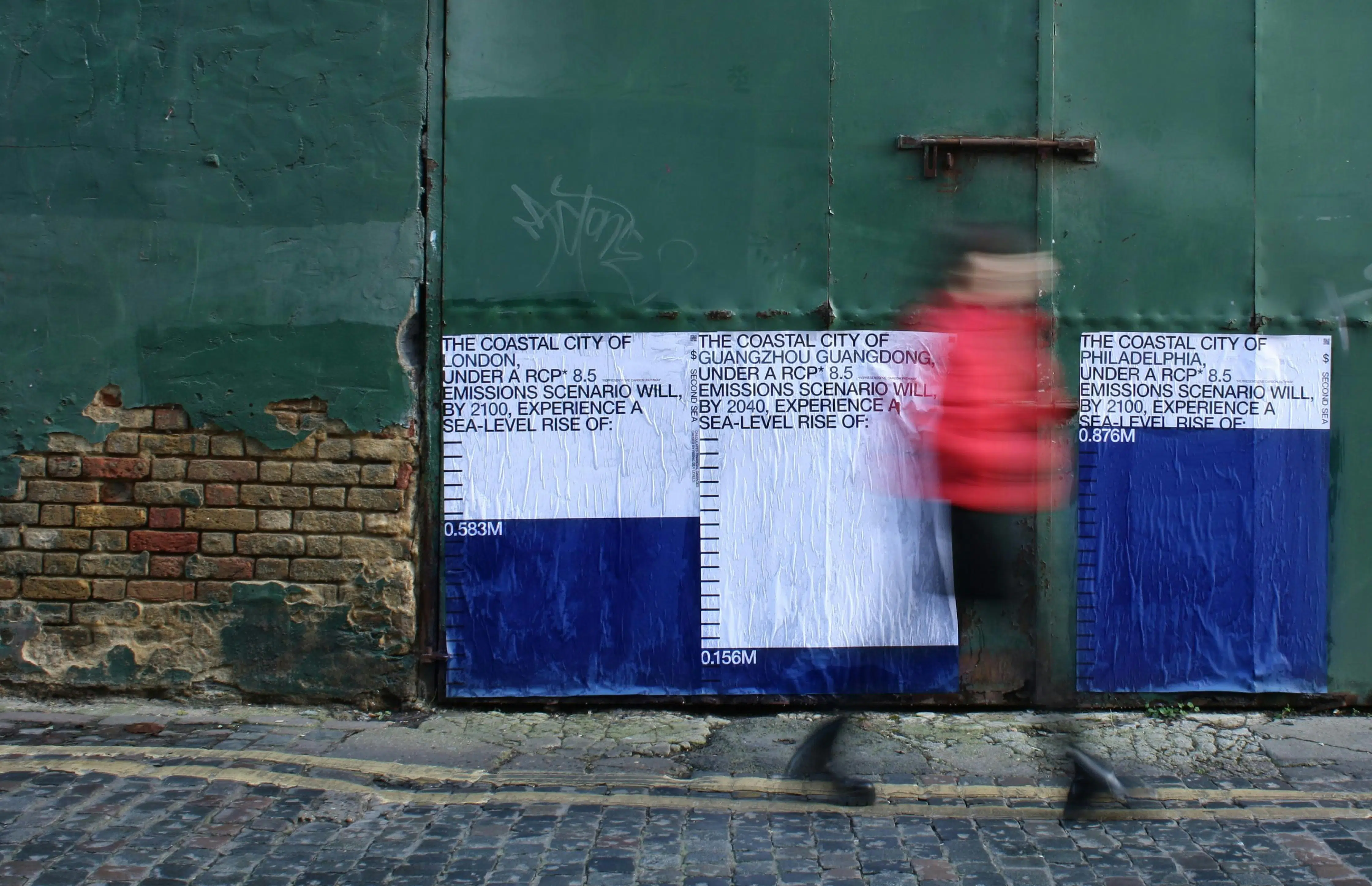 Set at ground level, the posters' flood blue acts as a 1:1 scale measure indicating how much higher the sea level will be for that particular city.